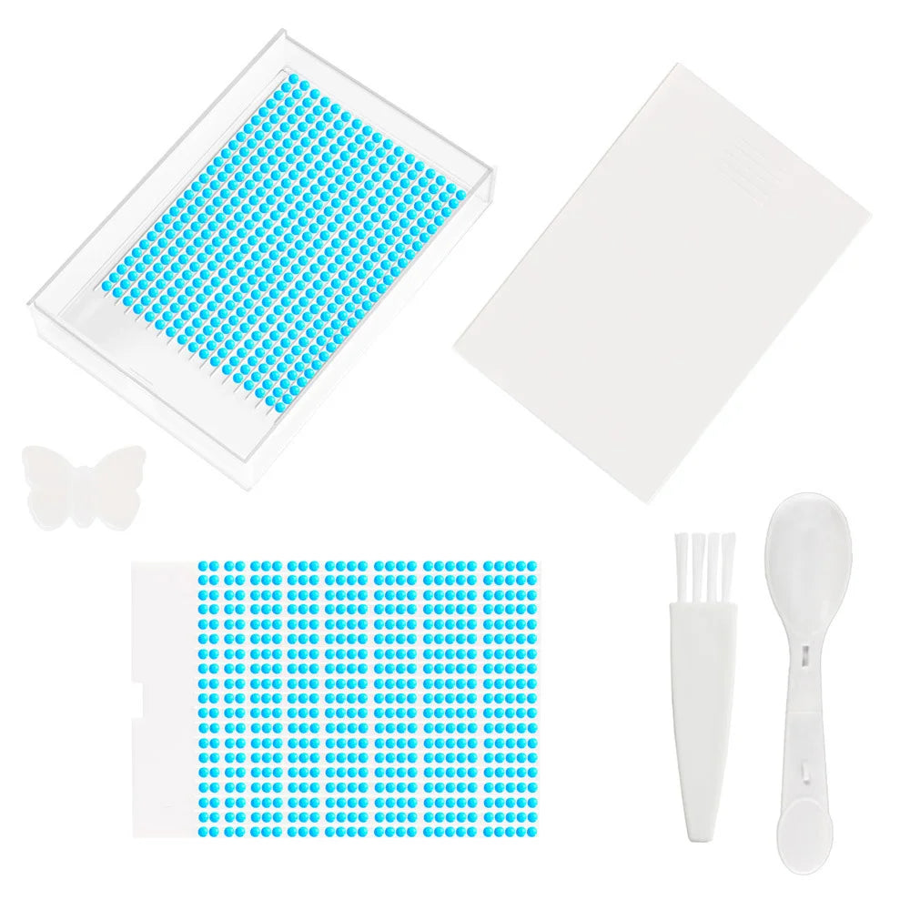 A clear diamond painting storage tray with a lid and a set of plastic tools for painting.