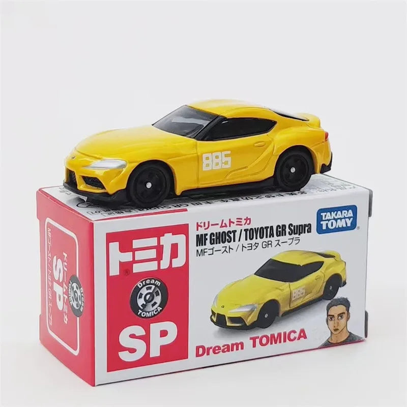 A yellow die-cast model of a sports car is displayed in its packaging box.