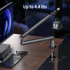 A black low profile microphone arm with a cable and an extension riser is shown on a desk.