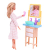 A pink doll wearing a pink coat stands next to a wooden vanity with a mirror and cleaning accessories.