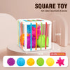 A white container holds six colorful soft rubber touch balls for a toddler shape-sorting toy set.