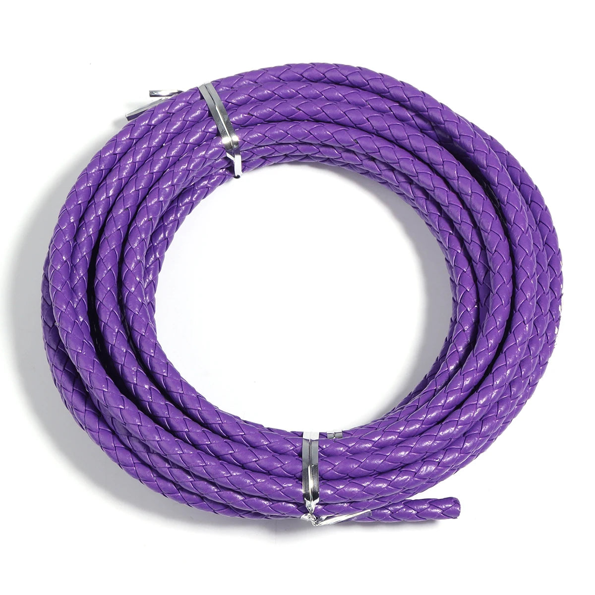 A coil of purple round braided leather cord used for jewelry making and DIY crafts.