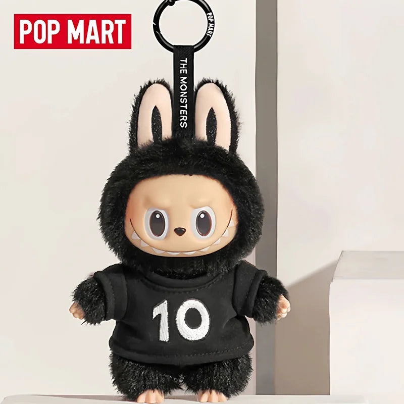 A black plush toy resembling a rabbit with large ears and a stitched mouth, featuring the number 10.