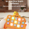 A child's hand is interacting with an orange Montessori busy board featuring light-up switches for a fingertip challenge game