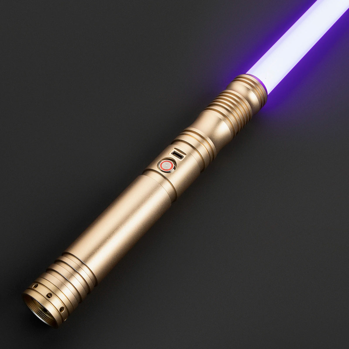 A close-up of a gold lightsaber with a glowing purple blade and a metallic hilt against a dark background.