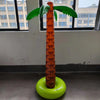 An oversized inflatable palm tree with an orange trunk and green fronds sits on a lime green base.