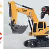 A yellow RC excavator with a black remote control and bucket is shown against a light gray background.