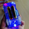 A hand holds a glowing blue LED race track car toy set featuring two racing cars.