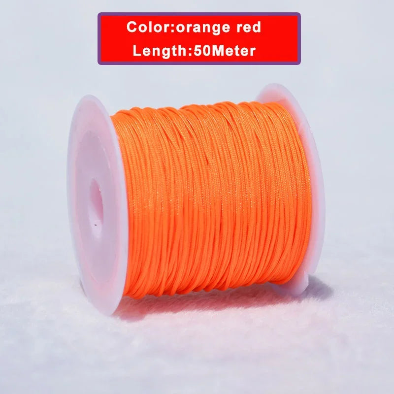 Orange red nylon knotting cord with a plastic spool, 50 meters long.