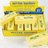 A box of Butter Squishy toys in yellow packaging with various butter-shaped squishies inside.