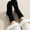 Black fleece-lined slouch socks worn on legs against a light background.