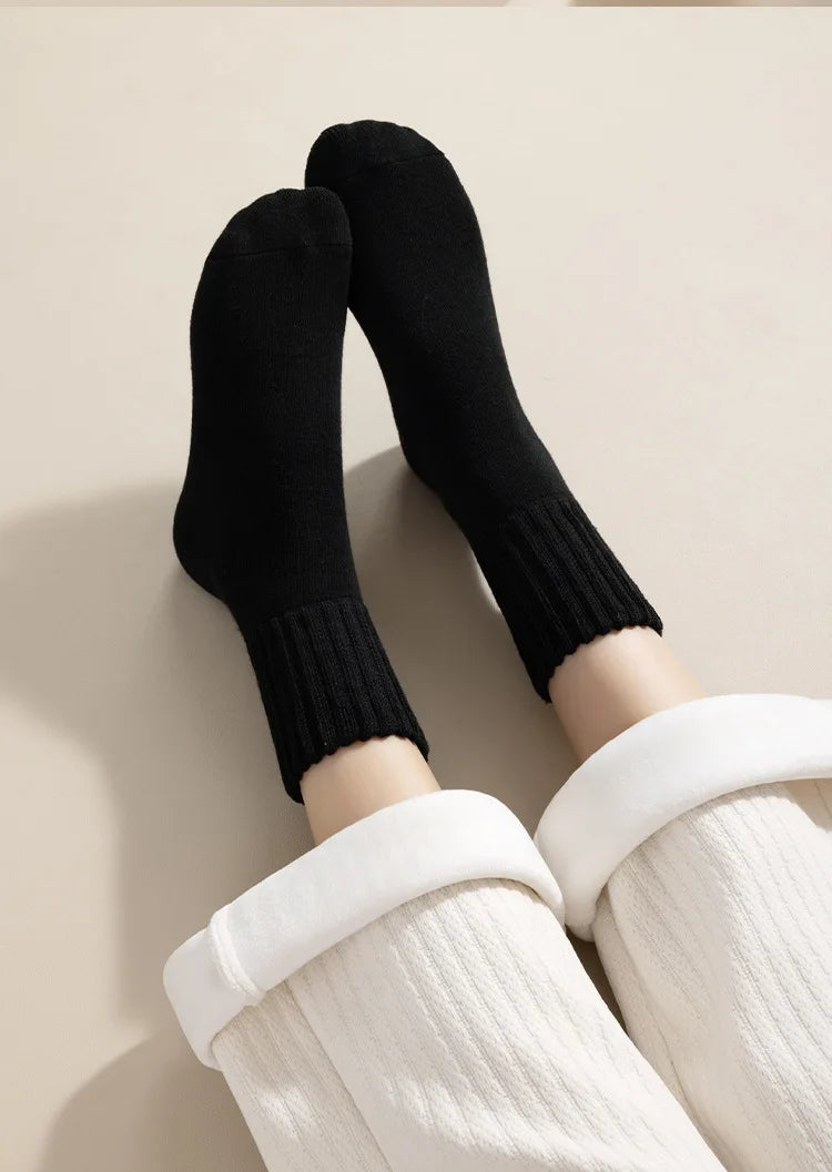 Black fleece-lined slouch socks worn on legs against a light background.
