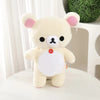 A cute white and pink Rilakkuma strawberry bear plush toy sitting on a white surface.