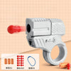 A silver mini shell-ejecting fidget pistol with a ring, showing various components like a red pellet and small shells.