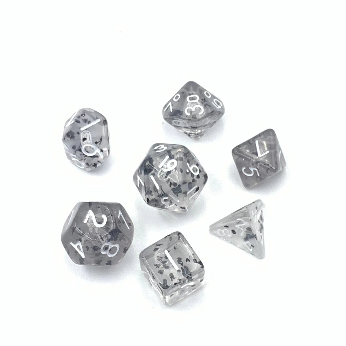 A set of seven 10mm transparent acrylic D6 dice showing various numbers and patterns.
