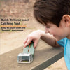 A boy is using a handheld insect catching tool with a magnifier to capture insects on a wooden surface.