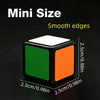 A black mini cube puzzle with smooth edges, featuring green and orange faces.