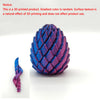 A close-up view of a 3D printed dragon egg fidget toy with a textured, iridescent purple and blue surface.