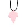 A pink silicone leaf pendant on a black necklace for teething and sensory calming.