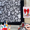 A DIY coloring blanket with 24 markers and a washable velvet throw is displayed next to some art supplies.