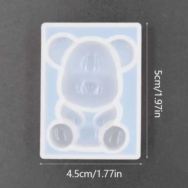 A clear silicone mold shaped like a bear for resin jewelry and crafts.