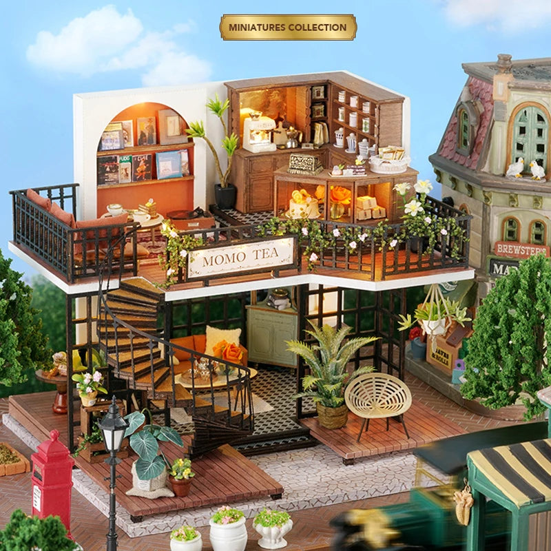 A detailed diorama of a miniature dollhouse featuring wooden structures, plants, and decorative elements.
