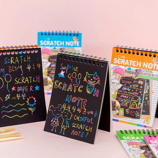 A collection of colorful scratch note pads and notebooks featuring various designs for kids
