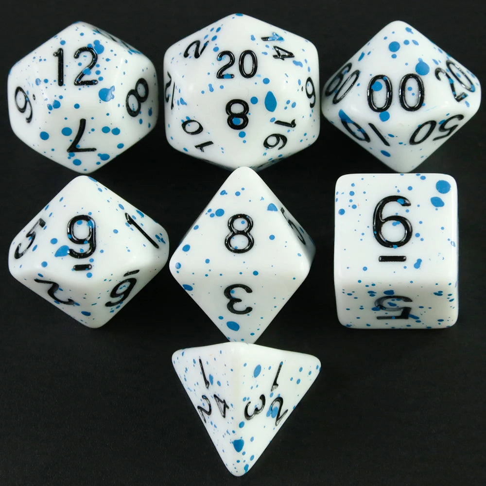 A collection of white acrylic dice showing various numbers and dots on a black surface.