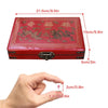 A red carrying case for a classic Chinese Mahjong set, shown next to a hand for scale.