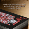 A stack of black playing cards with red designs is shown on a wooden surface.