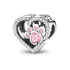 A heart-shaped sterling silver charm bead featuring a paw print design and pink zircon stones.