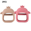Two pink silicone teethers shaped like heads for babies