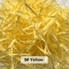 A pile of yellow raffia paper shreds used for gift boxes and baskets.