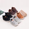 A collection of soft PU leather baby first walker shoes in brown, black, and tan colors with anti-slip soles.