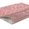 Pink sparkling rhinestone adhesive tape rolled up for DIY crafts and decor