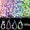 A colorful mix of acrylic beads in various shades of pink, purple, blue, and green for DIY jewelry making.