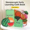 A green cloth book featuring watermelon and orange illustrations for early learning.