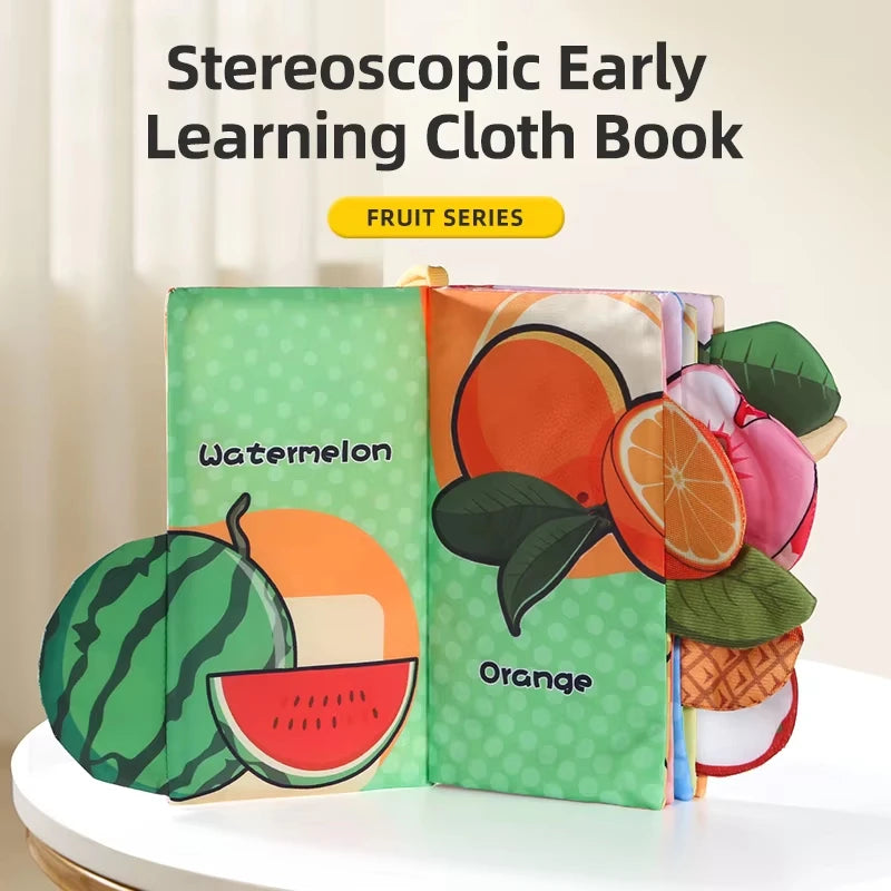A green cloth book featuring watermelon and orange illustrations for early learning.
