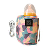 A pink and green camouflage insulated travel bag for a USB portable baby bottle warmer with a clear silicone nipple.