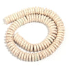 A strand of natural, light beige turquoise stone beads coiled into a circular shape.