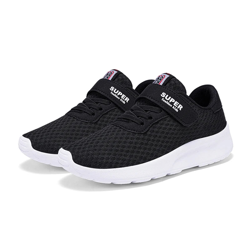 A pair of black and white breathable mesh kids' sneakers with hook-and-loop closure.