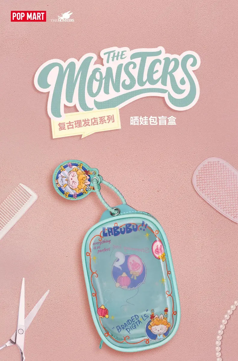 A light blue fabric bag with a purple and white design featuring a monster theme, used as a pendant keychain.
