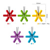 A set of five silicone steering wheel teethers in red, green, yellow, purple, and blue, showing different weights.