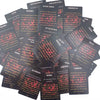A stack of black oracle cards featuring messages for love and confession, including themes like blessing, regret, and faith.
