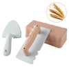 A set of pink and gray beach sand castle building tools including a shovel and a mold for kids