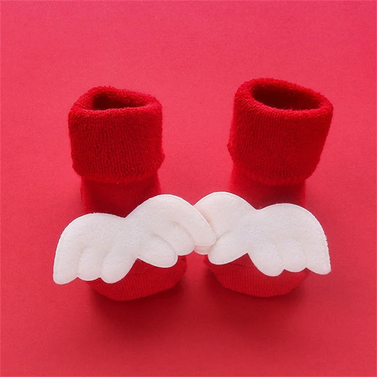 Pair of red knitted socks with white angel wings