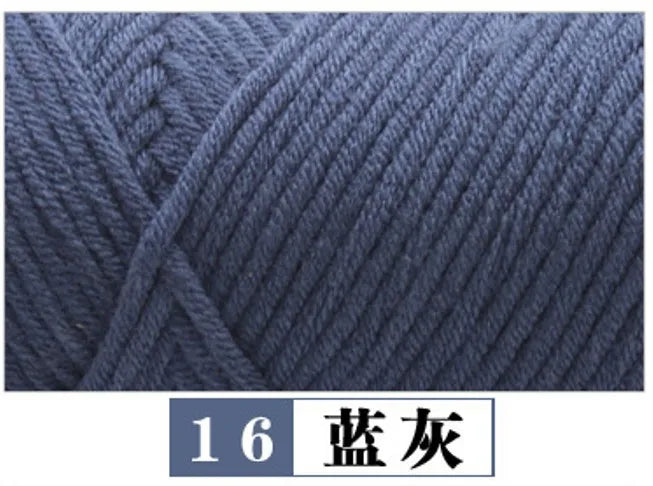 A close-up view of dark gray premium milk cotton yarn used for knitting or crafting.