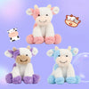 A collection of soft, cuddly cow plush toys in white, pink, purple, and blue colors.