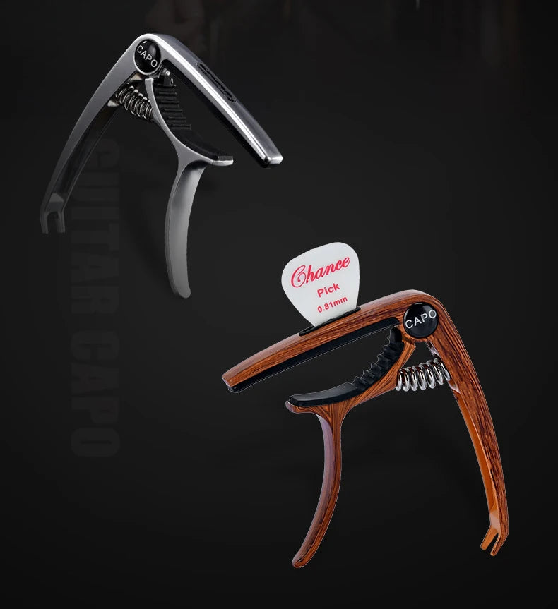 A professional metal guitar capo with a pick holder shown in a close-up view.