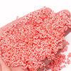 A handful of small red and white polymer clay slices for DIY crafts